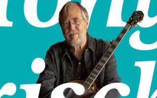 Tony Trischka holding a banjo, with text overlay that says, "Tony Trischka."
