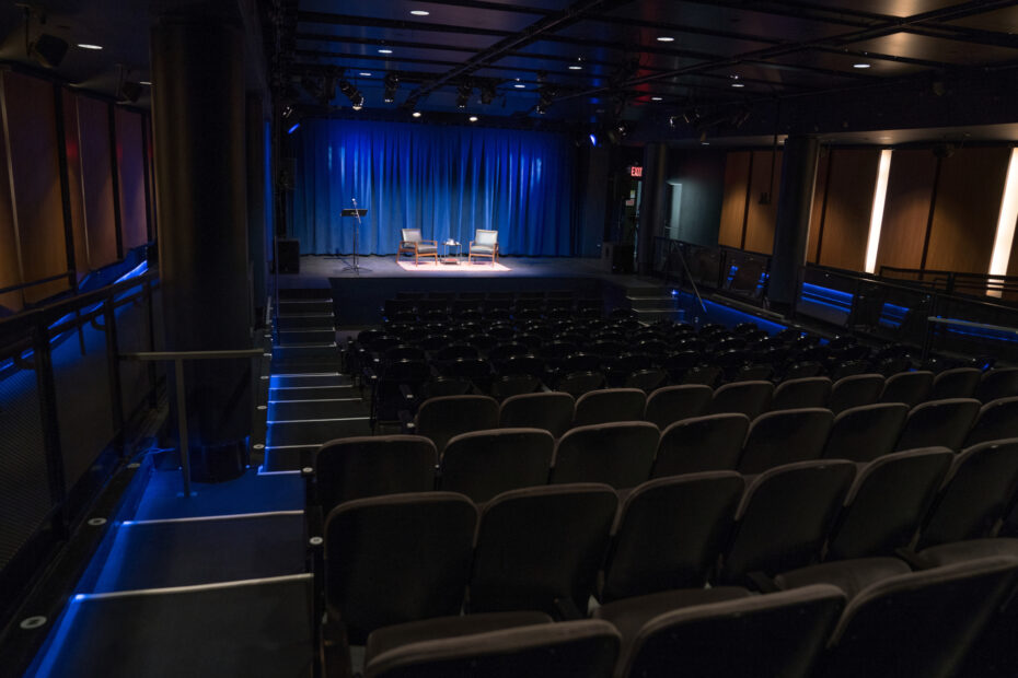 An empty theater and stage with two sitting chairs as seen from the back of the Leonard Nimoy Thalia.
