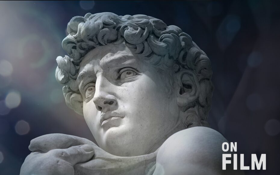 A sculpture by Michelangelo featuring the head and shoulders of a man with curly hair.