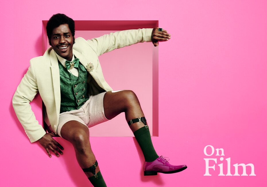 Ncuti Gatwa in The Importance of Being Earnest, in front of a pink background.