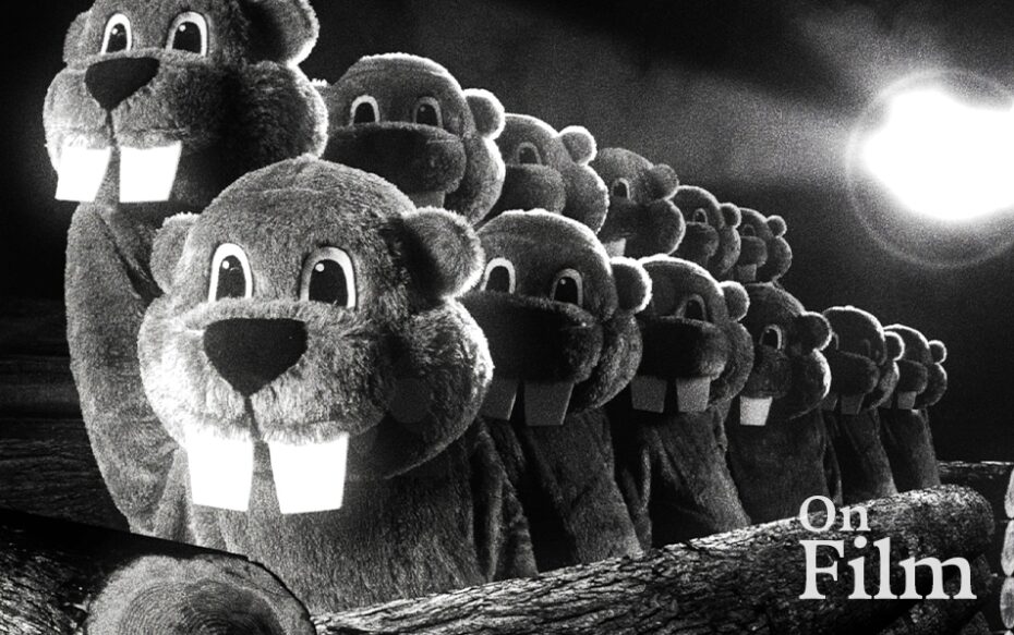 A still from the film Hundreds of Beavers, featuring several beavers in a line.