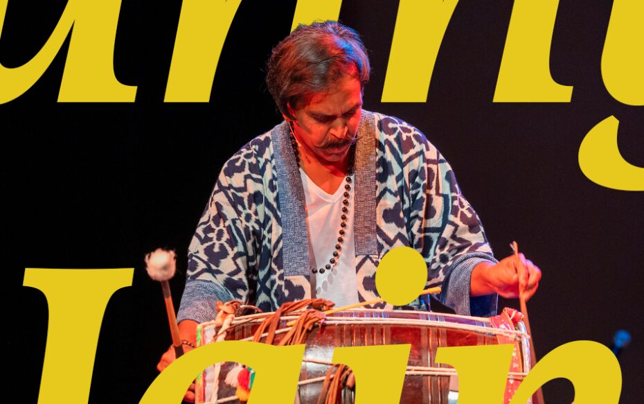 Sunny Jain performing on the stage, with text that says, "Sunny Jain."