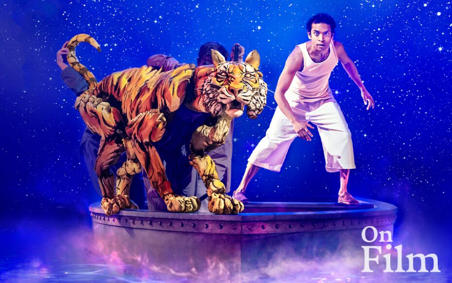 A scene from Life of Pi, featuring a man and a tiger puppet.