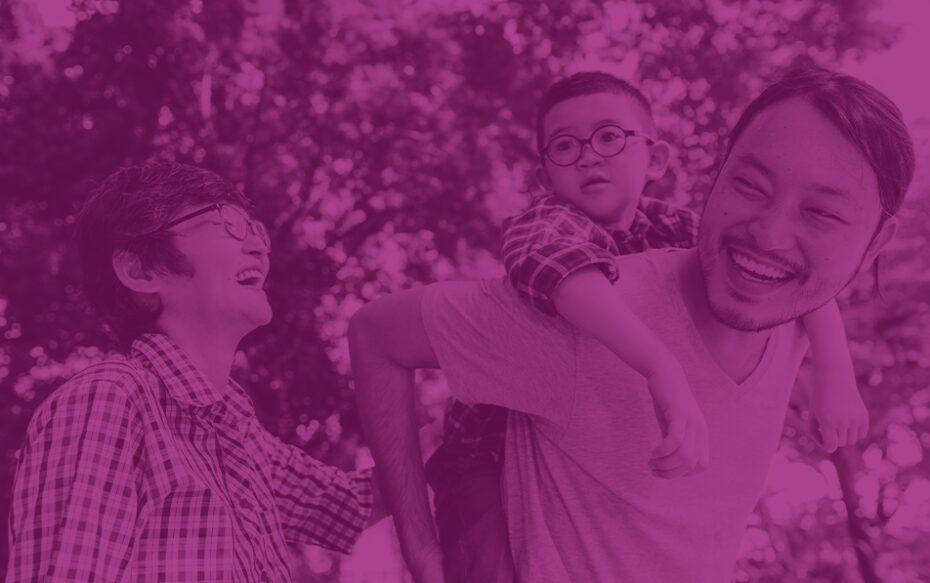 A purple-tinted image of an Asian family laughing in a park.