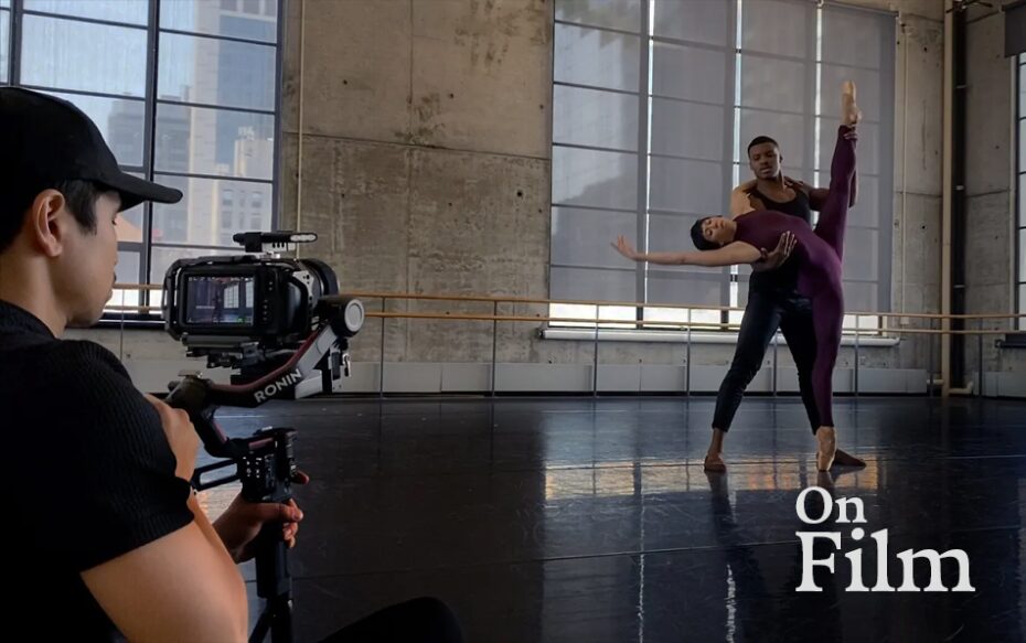 A person films two dancers.