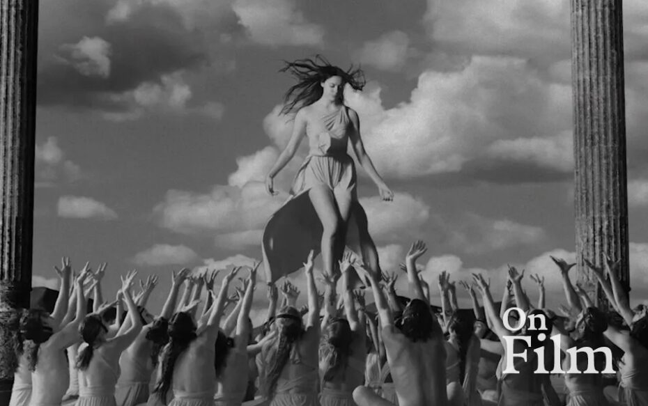 A group of people with their arms outstretched to a woman floating in the air.