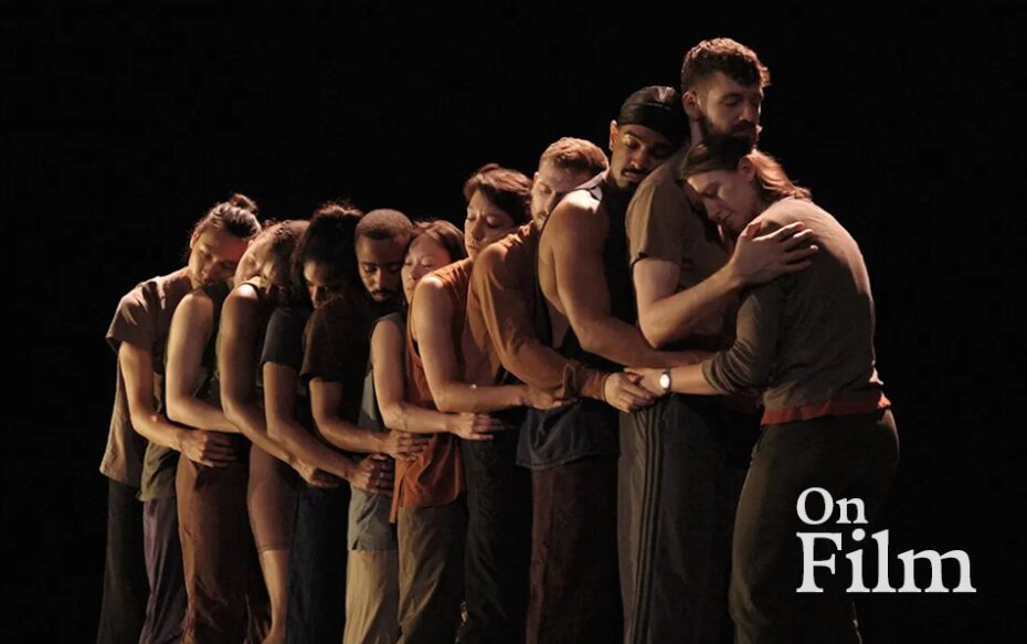 A group of dancers embracing each other.