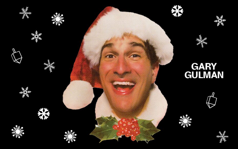 Against a black background patterned with white snowflakes and dreidels: a headshot of Gary Gulman wearing a red Santa hat. The comedian's name appears in white text on the right of the image.