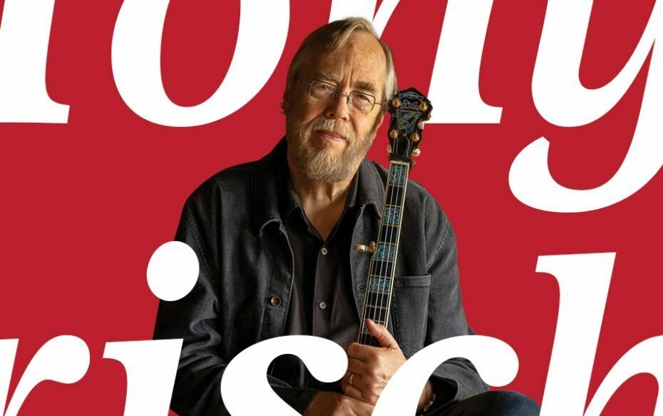 Tony Trischka in front of a red background with white text overlayed that says his name.