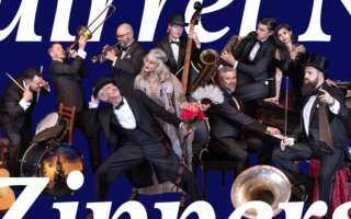 Squirrel Nut Zippers playing their instruments in front of a blue background, with text that says, "Squirrel Nut Zippers."