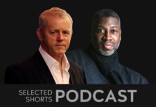 David Morse, a man with short, gray hair wearing a white button down shirt is with Teagle F Bougere, a man with facial hair looking at the camera wearing a black scarf tied around hisneck.