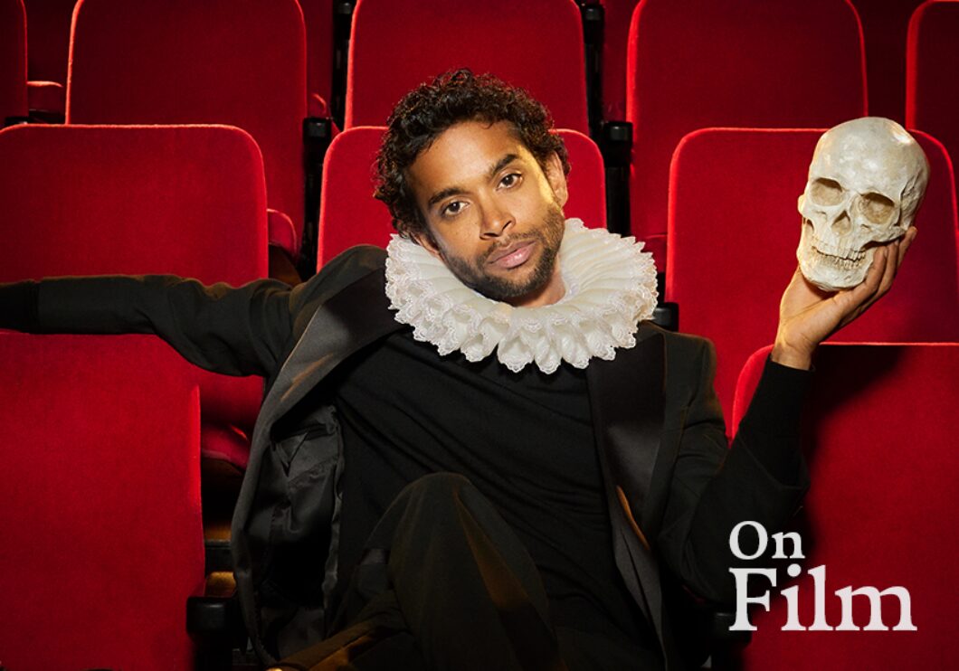 Hiran Abeysekera in costume as Hamlet, holding a skull.