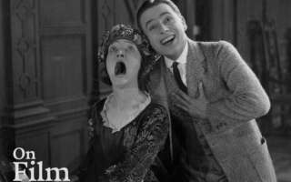 A scene from the film Bell Boy 13 featuring Douglas MacLean and Margaret Loomis.