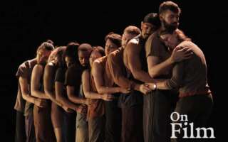 A group of dancers embracing each other.