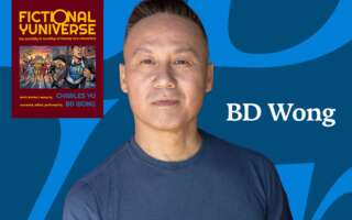 A headshot of BD Wong with a poster for Fictional Yuniverse.