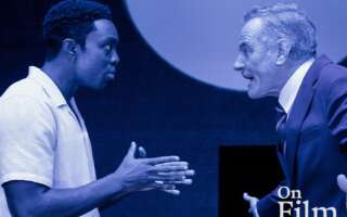 A still from All My Sons of two men talking.