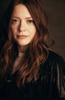 Colby Minfie headshot with a dark background