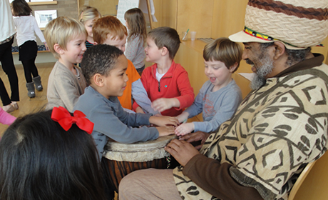 A group of students engage with an artist.