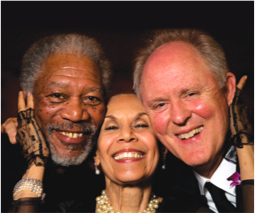 Carmen de Lavallade stands between Morgan Freeman and John Lithgow with her hands cupping their faces. All smile.